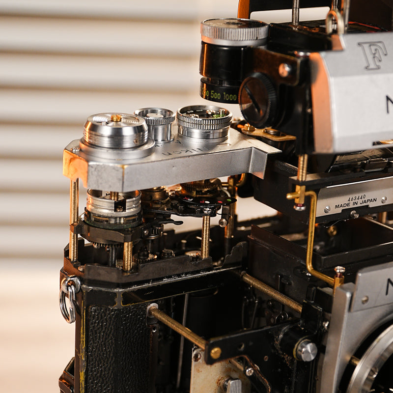 Disassembled Mechanical Film Camera Nikon F With cut lens