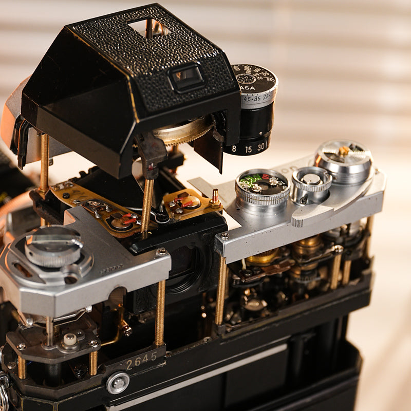 Disassembled Mechanical Film Camera Nikon F With cut lens