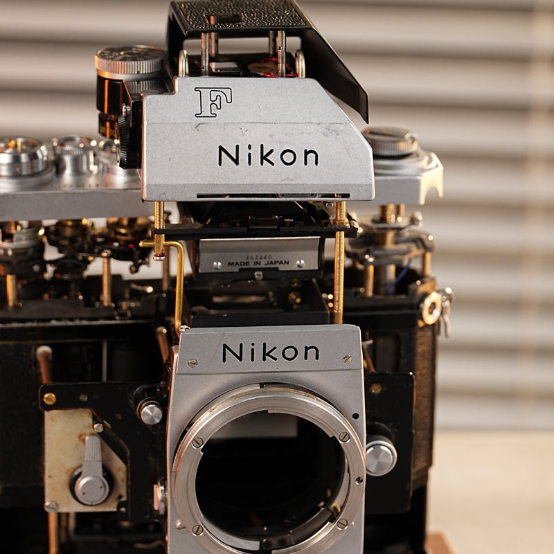 Disassembled Mechanical Film Camera Nikon F With cut lens
