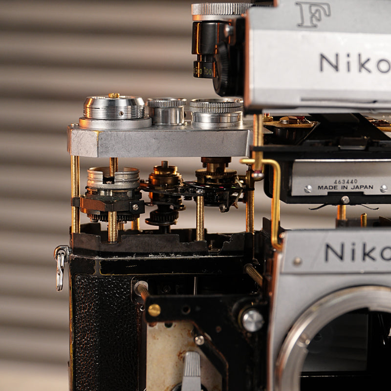 Disassembled Mechanical Film Camera Nikon F With cut lens