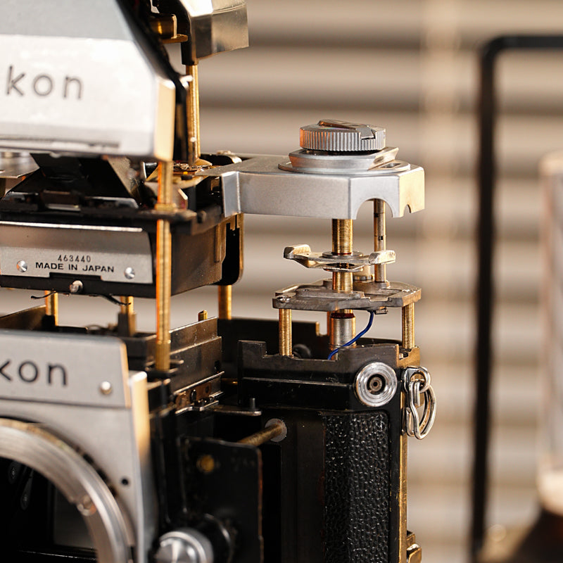 Disassembled Mechanical Film Camera Nikon F With cut lens